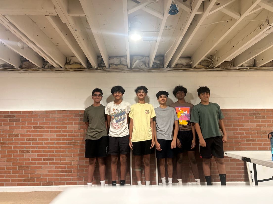 Image: a photo of team 26014's members together holding up a banner